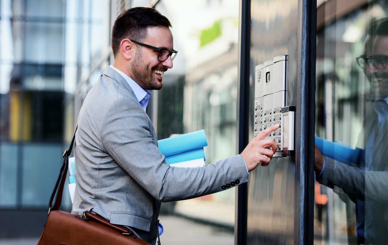 Man pushing the button and talking on the intercom